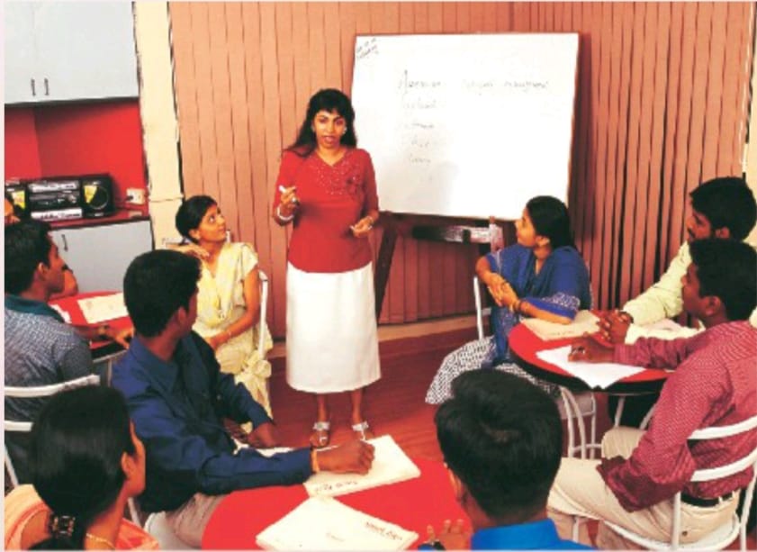 A Speak Easy trainer leading a circle-seated speaking session in Cuddalore