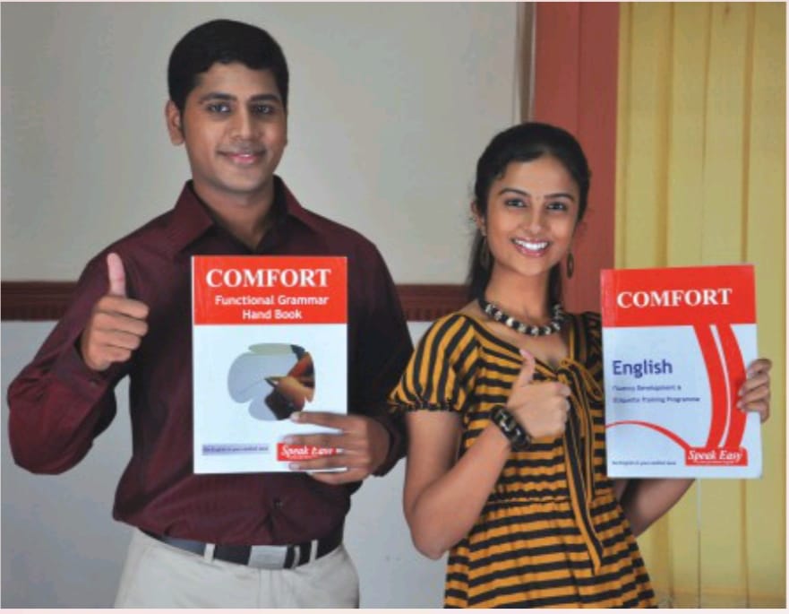 Two Speak Easy learners holding the Comfort English and Functional Grammar handbooks